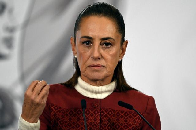(FILES) Mexico's President Claudia Sheinbaum gestures during her daily press conference at Palacio Nacional in Mexico City on January 12, 2026. Mexico was using all available "diplomatic channels" to ensure the resumption of crude shipments to struggling Cuba, which Washington has threatened to cut off from life-giving oil, President Claudia Sheinbaum said on February 3, 2026. (Photo by Alfredo ESTRELLA / AFP)