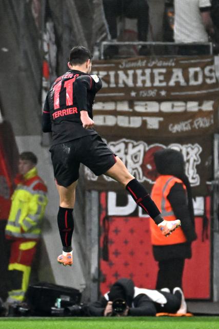 Bayer Leverkusen's French forward #11 Martin Terrier (C) jumps to celebrate after scoring the 1-0 goal during the German Cup (DFB-Pokal) quartefinal football match between Bayer 04 Leverkusen and FC St. Pauli in Leverkusen, western Germany on February 3, 2026. (Photo by UWE KRAFT / AFP) / DFB REGULATIONS PROHIBIT ANY USE OF PHOTOGRAPHS AS IMAGE SEQUENCES AND QUASI-VIDEO.