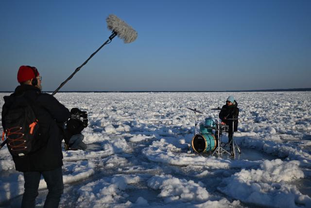 People play drums as they record a music video on the frozen Baltic Sea near Mikoszewo, northern Poland on February 3, 2026. (Photo by Sergei GAPON / AFP)