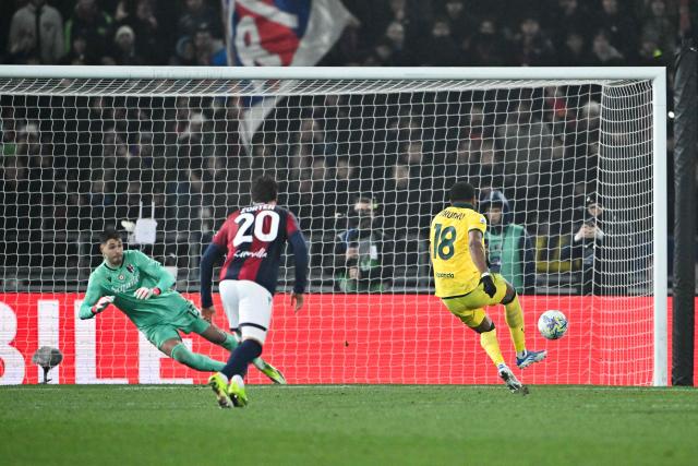 AC Milan's French forward #18 Christopher Nkunku (R) takes a penalty to score a goal during the Italian Serie A football match between Bologna and AC Milan at the Renato Dall'Ara stadium in Bologna on February 3, 2026. (Photo by Andreas SOLARO / AFP)