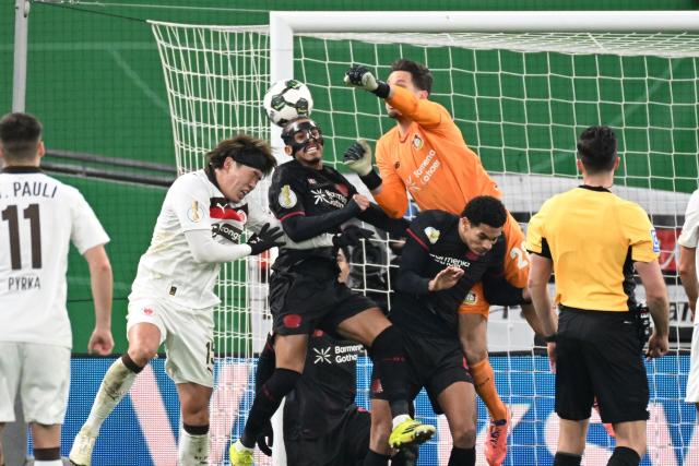 St Pauli's Japanese defender #15 Tomoya Ando (2nd L), Bayer Leverkusen's Argentinian midfielder #06 Ezequiel Fernandez (3rd L) and Bayer Leverkusen's German goalkeeper #28 Janis Blaswich (3rd R, top) vie for the ball during the German Cup (DFB-Pokal) quartefinal football match between Bayer 04 Leverkusen and FC St. Pauli in Leverkusen, western Germany on February 3, 2026. (Photo by UWE KRAFT / AFP) / DFB REGULATIONS PROHIBIT ANY USE OF PHOTOGRAPHS AS IMAGE SEQUENCES AND QUASI-VIDEO.