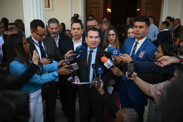 Venezuela's National Assembly opposition deputy Tomas Guanipa (C) speaks with the press after a National Assembly session in Caracas on February 3, 2026. Thousands of backers of Venezuela's former leader Nicolas Maduro, who was ousted in a deadly US military operation, marched in Caracas on February 3 to demand his freedom. (Photo by Federico PARRA / AFP)