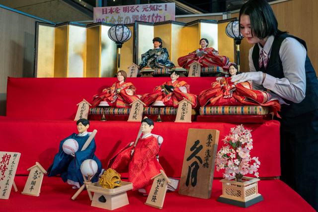 Hina dolls modeled after notable figures expected to make an impact this year including Japanese Major League baseball players, Los Angeles Dodgers' Shohei Ohtani (front L), Chicago White Sox's Munetaka Murakami (front R), as well as Olympic athletes, are displayed at the doll maker Kyugetsu in Tokyo on February 4, 2026, in anticipation of Hina Matsuri or Girls' Day on March 3, a festival celebrating health and happiness of young girls. (Photo by Kazuhiro NOGI / AFP)
