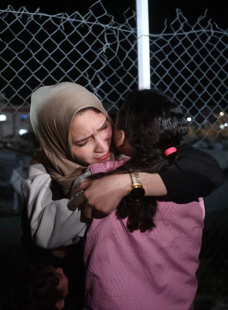 Palestinian women, coming from the Rafah crossing with Egypt, hug as they arrive at Nasser Hospital in Khan Yunis in the southern Gaza Strip on February 4, 2026. Gazans long-separated from their loved ones shed tears of joy after the limited reopening of the Rafah crossing with Egypt allowed a handful to finally return to the war-shattered territory. Jubilant crowds filmed on their phones as they flocked around a bus carrying returnees to Nasser Hospital in the southern city of Khan Yunis late in the night. (Photo by Bashar Taleb / AFP)