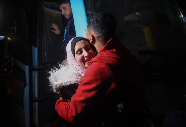 Palestinians, coming from the Rafah crossing with Egypt, arrive at Nasser Hospital in Khan Yunis in the southern Gaza Strip on February 4, 2026. Gazans long-separated from their loved ones shed tears of joy after the limited reopening of the Rafah crossing with Egypt allowed a handful to finally return to the war-shattered territory. Jubilant crowds filmed on their phones as they flocked around a bus carrying returnees to Nasser Hospital in the southern city of Khan Yunis late in the night. (Photo by Bashar Taleb / AFP)