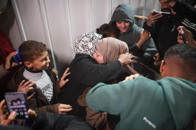 Palestinians coming from the Rafah crossing from Egypt arrive at Nasser Hospital in Khan Yunis in the southern Gaza Strip on February 4, 2026. Gazans long-separated from their loved ones shed tears of joy after the limited reopening of the Rafah crossing with Egypt allowed a handful to finally return to the war-shattered territory. Jubilant crowds filmed on their phones as they flocked around a bus carrying returnees to Nasser Hospital in the southern city of Khan Yunis late in the night. (Photo by Bashar Taleb / AFP)
