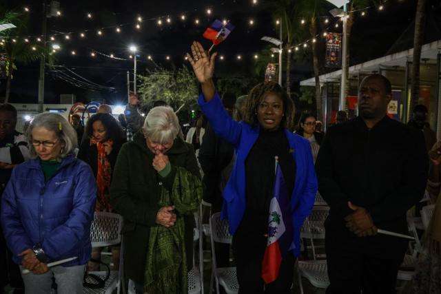 People pray during a candlelight vigil for Haitians living in the US under the Temporary Protected Status (TPS) immigration program in Miami, Florida on February 3, 2026. Late on February 2, federal judge Ana C. Reyes of the Federal District Court in Washington, blocked the Trump administration from ending TPS for an estimated 350,000 Haitian immigrants. The status, which offers protection from deportation and work authorization, was set to expire on Feb. 3. (Photo by Giorgio Viera / AFP)