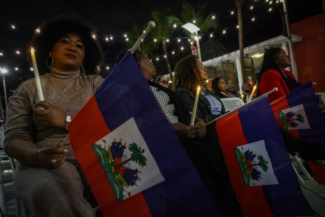 People attend a candlelight vigil for Haitians living in the US under the Temporary Protected Status (TPS) immigration program in Miami, Florida on February 3, 2026. Late on February 2, federal judge Ana C. Reyes of the Federal District Court in Washington, blocked the Trump administration from ending TPS for an estimated 350,000 Haitian immigrants. The status, which offers protection from deportation and work authorization, was set to expire on Feb. 3. (Photo by Giorgio Viera / AFP)