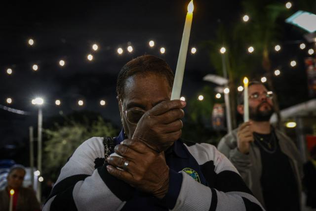 People attend a candlelight vigil for Haitians living in the US under the Temporary Protected Status (TPS) immigration program in Miami, Florida on February 3, 2026. Late on February 2, federal judge Ana C. Reyes of the Federal District Court in Washington, blocked the Trump administration from ending TPS for an estimated 350,000 Haitian immigrants. The status, which offers protection from deportation and work authorization, was set to expire on Feb. 3. (Photo by Giorgio Viera / AFP)