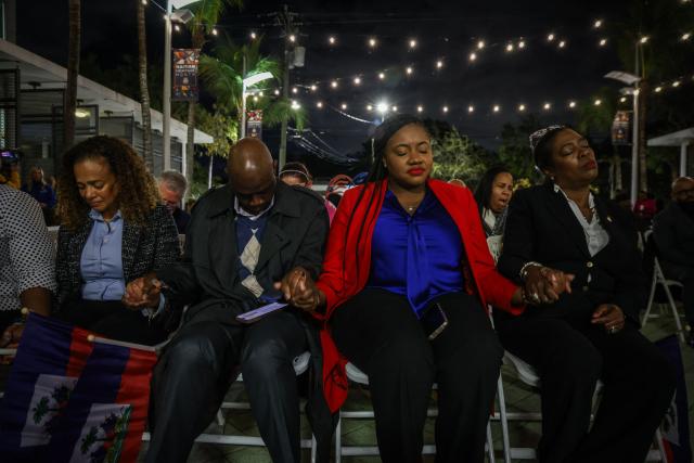 People pray during a candlelight vigil for Haitians living in the US under the Temporary Protected Status (TPS) immigration program in Miami, Florida on February 3, 2026. Late on February 2, federal judge Ana C. Reyes of the Federal District Court in Washington, blocked the Trump administration from ending TPS for an estimated 350,000 Haitian immigrants. The status, which offers protection from deportation and work authorization, was set to expire on Feb. 3. (Photo by Giorgio Viera / AFP)