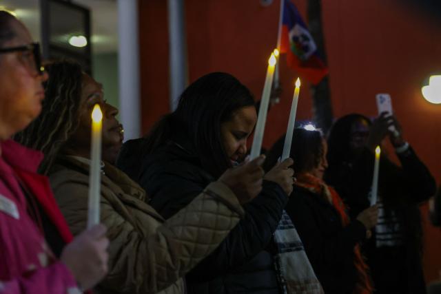 People attend a candlelight vigil for Haitians living in the US under the Temporary Protected Status (TPS) immigration program in Miami, Florida on February 3, 2026. Late on February 2, federal judge Ana C. Reyes of the Federal District Court in Washington, blocked the Trump administration from ending TPS for an estimated 350,000 Haitian immigrants. The status, which offers protection from deportation and work authorization, was set to expire on Feb. 3. (Photo by Giorgio Viera / AFP)