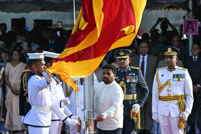 Sri Lanka's President Anura Kumara Dissanayake (C) hoists the national flag during the country's 78th Independence Day celebrations at Independence Square in Colombo on February 4, 2026. (Photo by Ishara S. KODIKARA / AFP)