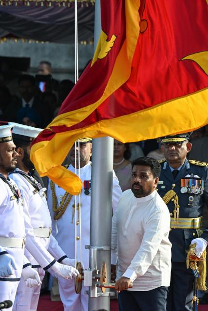 Sri Lanka's President Anura Kumara Dissanayake (C) hoists the national flag during the country's 78th Independence Day celebrations at Independence Square in Colombo on February 4, 2026. (Photo by Ishara S. KODIKARA / AFP)