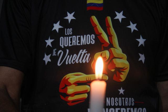 Supporters of ousted President Nicolas Maduro wear T-shirts reading ‘We want them back’ during a vigil in San Cristobal, Tachira state, on February 3, 2026. Thousands of backers of Venezuela's former leader Nicolas Maduro, who was ousted in a deadly US military operation, marched in Caracas on February 3 to demand his freedom. (Photo by JOHNNY PARRA / AFP)