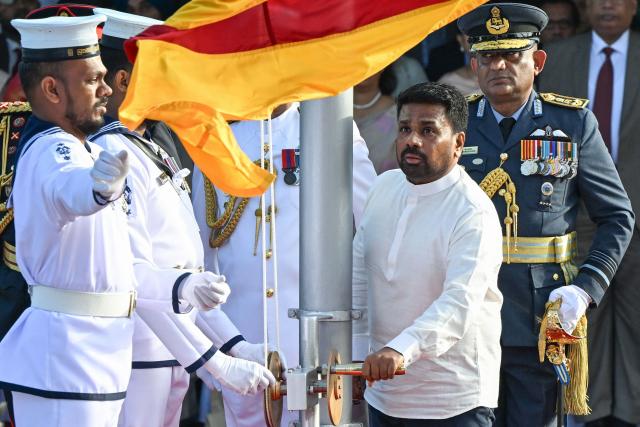 Sri Lanka's President Anura Kumara Dissanayake (C) hoists the national flag during the country's 78th Independence Day celebrations at Independence Square in Colombo on February 4, 2026. (Photo by Ishara S. KODIKARA / AFP)
