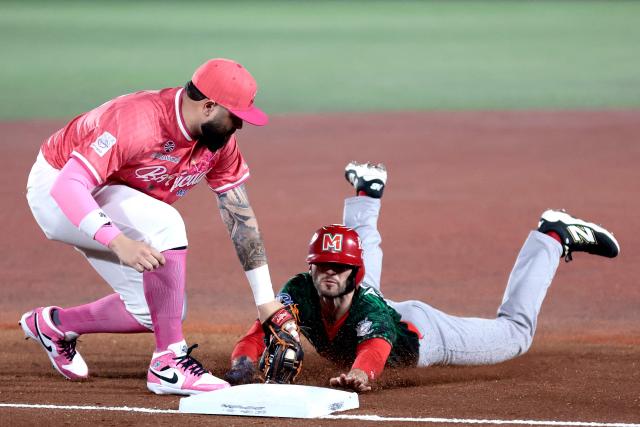 Charros de Jalisco's #26 Michael Wielansky dives to third base as Cangrejeros de Santurce's #26 Emmanuel Rivera catches the ball in the first inning of the Caribbean Series baseball tournament sixth game between Mexico's Charros de Jalisco and Puerto Rico's Cangrejeros de Santurce at the Panamerican Stadium in Jalisco, Mexico, on February 3, 2026. (Photo by Ulises Ruiz / AFP)