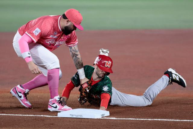 Charros de Jalisco's #26 Michael Wielansky dives to third base as Cangrejeros de Santurce's #26 Emmanuel Rivera catches the ball in the first inning of the Caribbean Series baseball tournament sixth game between Mexico's Charros de Jalisco and Puerto Rico's Cangrejeros de Santurce at the Panamerican Stadium in Jalisco, Mexico, on February 3, 2026. (Photo by Ulises Ruiz / AFP)
