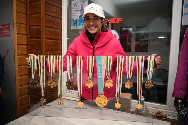 (FILES) French skier Perrine Laffont, five-time world champion in mogul skiing, poses with her medals, at the Monts d'Olmes, her home station, in Montferrier, southwestern France, on March 11, 2023. In the heart of Ariege, in the Monts d'Olmes resort where Olympic champion Perrine Laffont grew up, heavy snowfall like this winter is increasingly rare because of climate change, which is forcing a new way of "approaching the mountains". (Photo by Valentine CHAPUIS / AFP)