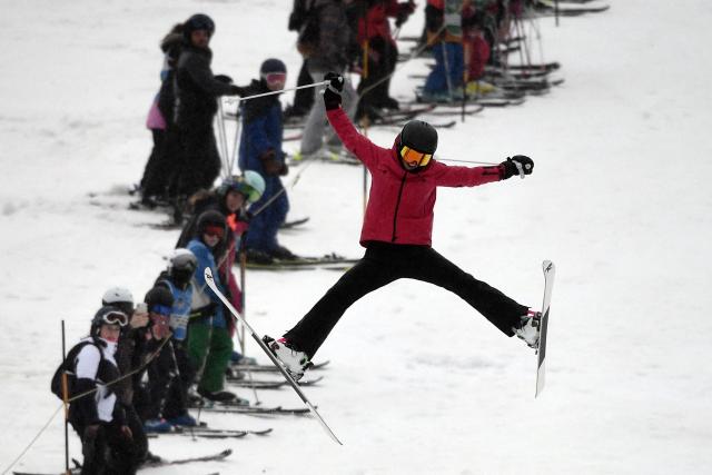 (FILES) French skier Perrine Laffont (R), five-time world champion in mogul skiing, takes a jump at the Monts d'Olmes, her home station, in Montferrier, southwestern France, on March 11, 2023. In the heart of Ariege, in the Monts d'Olmes resort where Olympic champion Perrine Laffont grew up, heavy snowfall like this winter is increasingly rare because of climate change, which is forcing a new way of "approaching the mountains". (Photo by Valentine CHAPUIS / AFP)