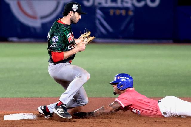 Cangrejeros de Santurce's #2 Jeremy Arrocho dives to second base as Charros de Jalisco's #26 Michael Wielansky cathces the ball in the ninth inning of the Caribbean Series baseball tournament sixth game between Mexico's Charros de Jalisco and Puerto Rico's Cangrejeros de Santurce at the Panamerican Stadium in Jalisco, Mexico, on February 3, 2026. (Photo by Ulises Ruiz / AFP)