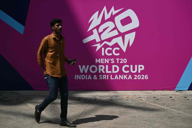 A man walks past a billboard advertising the 2026 ICC Men's T20 Cricket World Cup, at the MA Chidambaram Stadium in Chennai on February 4, 2026. The month-long 2026 ICC Mens T20 Cricket World Cup co-hosted by India and Sri Lanka begins on February 7. (Photo by R.Satish BABU / AFP)