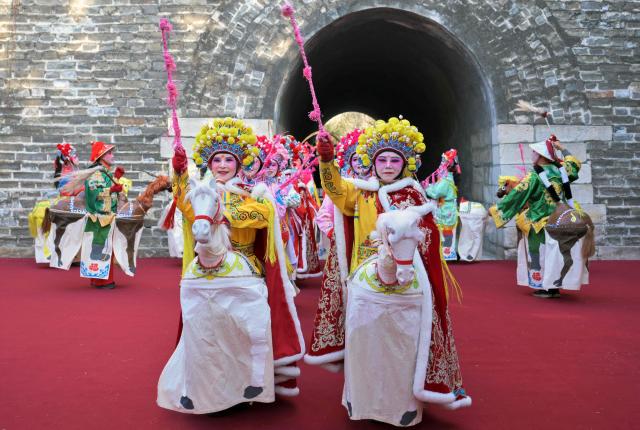 Dancers perform during the start of the Spring Culture Festival which falls on the day of Lichun, or the beginning of the first of the 24 solar terms in the Chinese calendar, at the Ancient Observatory building in Beijing on February 4, 2026. (Photo by Adek BERRY / AFP)