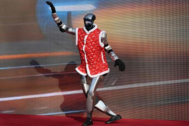 A robot made by the Lingchuang (Baoding) Technology robotics company performs a dance during the start of the Spring Culture Festival which falls on the day of Lichun, or the beginning of the first of the 24 solar terms in the Chinese calendar, at the Ancient Observatory building in Beijing on February 4, 2026. (Photo by Adek BERRY / AFP)