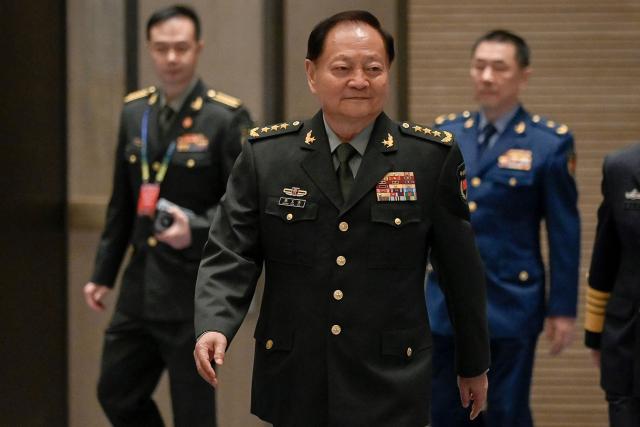 (FILES) China's vice chairman of the CPC Central Military Commission and vice chairman of the Central Military Commission of the People's Republic of China Zhang Youxia (C) arrives for a group photo before the opening ceremony of the 19th Western Pacific Naval Symposium in Qingdao, China's Shandong province on April 22, 2024. China's announcement its top general was under investigation stunned defence watchers, hollowing out the country's top military body and confirming President Xi Jinping's far-reaching power. (Photo by WANG Zhao / AFP)