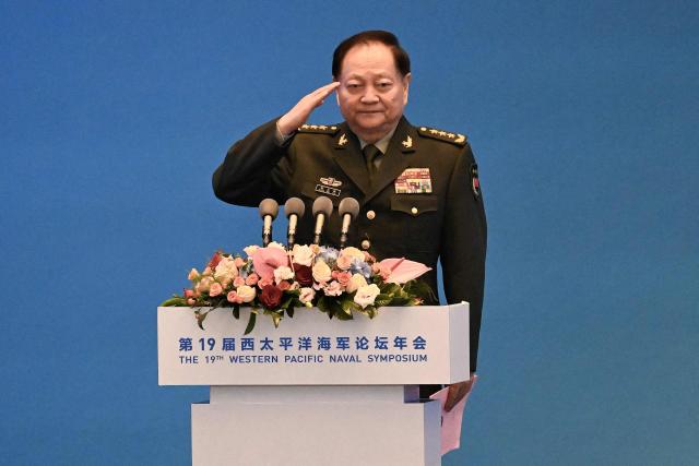 (FILES) Vice chairman of the CPC Central Military Commission and vice chairman of the Central Military Commission of the People's Republic of China Zhang Youxia salutes before delivering his speech during the opening ceremony of the 19th Western Pacific Naval Symposium in Qingdao, China's Shandong province on April 22, 2024. China's announcement its top general was under investigation stunned defence watchers, hollowing out the country's top military body and confirming President Xi Jinping's far-reaching power. (Photo by WANG Zhao / AFP)