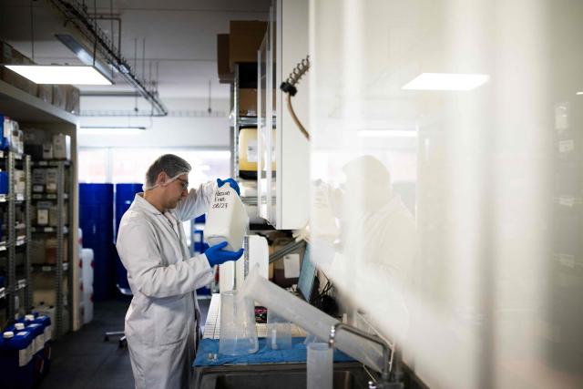 An employee mixes ingredients to create e-liquid for electronic cigarettes, at the Fuu factory in Paris on February 3, 2026. (Photo by Julie SEBADELHA / AFP)