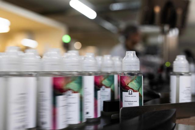 This photograph shows bottles of e-liquid for electronic cigarettes at the Fuu factory in Paris on February 3, 2026. (Photo by Julie SEBADELHA / AFP)