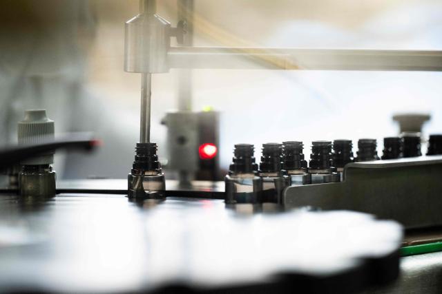 This photograph shows a bottle being filled of e-liquid for electronic cigarettes, at the Fuu factory in Paris on February 3, 2026. (Photo by Julie SEBADELHA / AFP)
