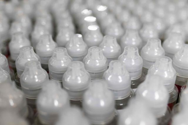 This photograph shows bottles of e-liquid for electronic cigarettes at the Fuu factory in Paris on February 3, 2026. (Photo by Julie SEBADELHA / AFP)