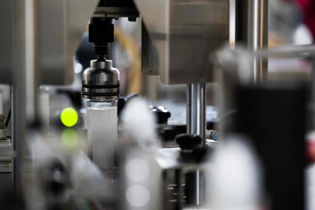 This photograph shows a bottle of e-liquid for electronic cigarettes with a cap being put on, at the Fuu factory in Paris on February 3, 2026. (Photo by Julie SEBADELHA / AFP)