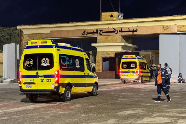 Ambulances wait on the Egyptian side of the Rafah border crossing with the Gaza Strip on February 4, 2026, days after Israel permitted a limited reopening of the Palestinian territory's border post. The crossing, which is Gaza's only gateway to the outside world that does not lead to Israel, had been largely closed since Israeli forces seized control of it in May 2024 during the war with Hamas. (Photo by AFP)