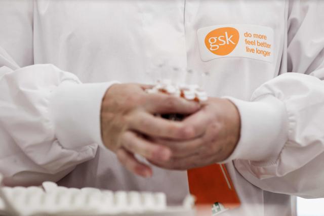 (FILES) A GSK employee works at the factory of British pharmaceutical company GlaxoSmithKline (GSK) in Wavre on February 8, 2021. British pharmaceutical group GSK reported on February 4, 2026 a sharp rise in net profit last year, boosted by strong HIV, respiratory and cancer drug sales as it recovered from costly US lawsuits over its Zantac heartburn drug. (Photo by Kenzo TRIBOUILLARD / AFP)