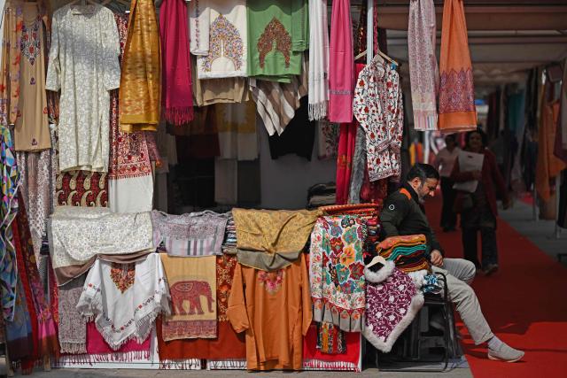 A shopkeeper waits for customers at a market in New Delhi on February 4, 2026. (Photo by Sajjad HUSSAIN / AFP)