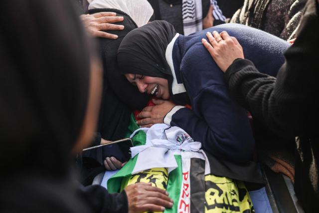 A woman mourns over the body of Saeed Nael al-Sheikh, a 24-year-old Palestinian who was reportedly killed by Israeli forces, during his funeral in the city of Jericho in the Israeli-occupied West Bank on February 4, 2026. Palestinian health officials said on February 3, that Israeli forces shot dead a Palestinian man and wounded three others in the occupied West Bank city of Jericho. The Israeli military said soldiers opened fire after "rocks" were thrown at them. (Photo by AHMAD GHARABLI / AFP)