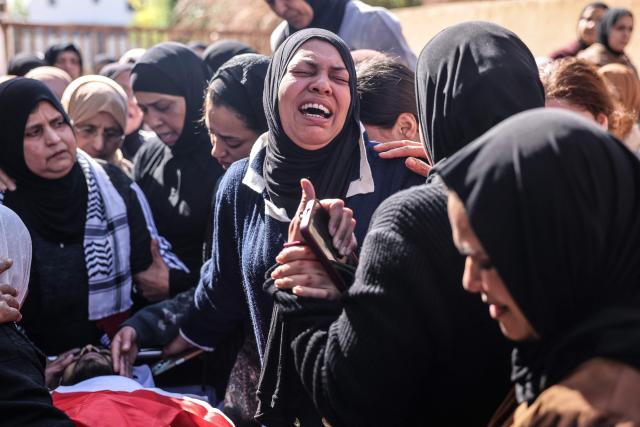 EDITORS NOTE: Graphic content / Women mourn over the body of Saeed Nael al-Sheikh, a 24-year-old Palestinian who was reportedly killed by Israeli forces, during his funeral in the city of Jericho in the Israeli-occupied West Bank on February 4, 2026. Palestinian health officials said on February 3, that Israeli forces shot dead a Palestinian man and wounded three others in the occupied West Bank city of Jericho. The Israeli military said soldiers opened fire after "rocks" were thrown at them. (Photo by AHMAD GHARABLI / AFP)