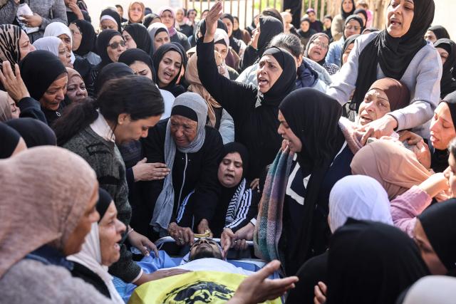 EDITORS NOTE: Graphic content / Women mourn over the body of Saeed Nael al-Sheikh, a 24-year-old Palestinian who was reportedly killed by Israeli forces, during his funeral in the city of Jericho in the Israeli-occupied West Bank on February 4, 2026. Palestinian health officials said on February 3, that Israeli forces shot dead a Palestinian man and wounded three others in the occupied West Bank city of Jericho. The Israeli military said soldiers opened fire after "rocks" were thrown at them. (Photo by AHMAD GHARABLI / AFP)