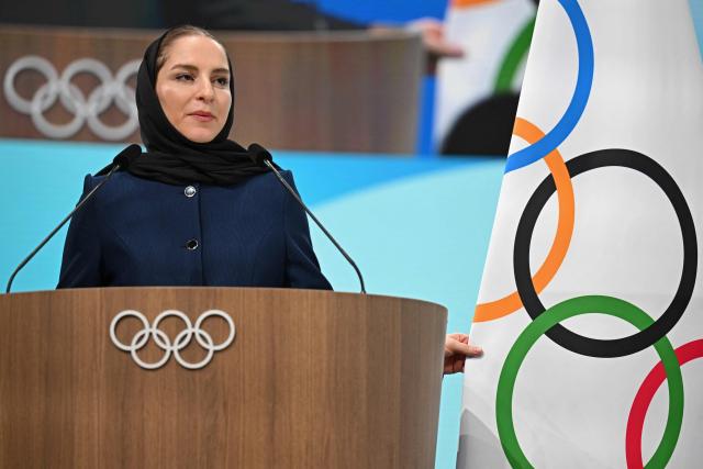 Iranian badminton player Soraya Aghaei Hajiagha, speaks during her oath ceremony as the newly appointed member of International Olympic Committee (IOC) at the 145th IOC session ahead of the Milano Cortina 2026 Winter Olympic Games, in Milan on February 4, 2026. (Photo by Piero CRUCIATTI / AFP)