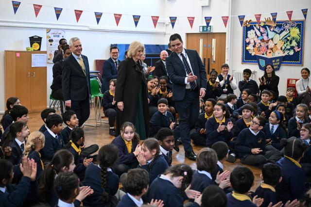 Britain's Queen Camilla (C) arrives to attend a talk by British children's author Chris Smith (not pictured) as she attends the opening of a library at Christ Church Primary School in London on February 4, 2026, to help mark the "National Year of Reading". (Photo by JUSTIN TALLIS / POOL / AFP)