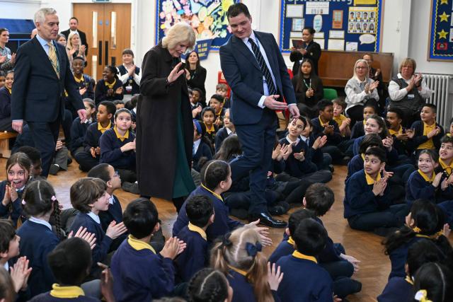 Britain's Queen Camilla (C) arrives to attend a talk by British children's author Chris Smith (not pictured) as she attends the opening of a library at Christ Church Primary School in London on February 4, 2026, to help mark the "National Year of Reading". (Photo by JUSTIN TALLIS / POOL / AFP)
