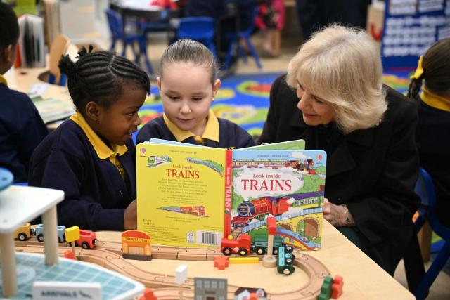 Britain's Queen Camilla (R) meets with pupils as she attends the opening of a library at Christ Church Primary School in London on February 4, 2026, to help mark the "National Year of Reading". (Photo by JUSTIN TALLIS / POOL / AFP)