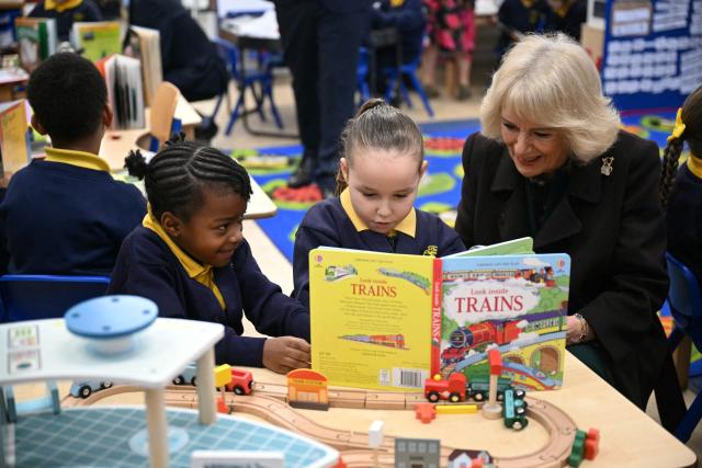Britain's Queen Camilla (R) meets with pupils as she attends the opening of a library at Christ Church Primary School in London on February 4, 2026, to help mark the "National Year of Reading". (Photo by JUSTIN TALLIS / POOL / AFP)