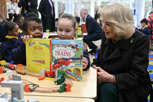 Britain's Queen Camilla (R) meets with pupils as she attends the opening of a library at Christ Church Primary School in London on February 4, 2026, to help mark the "National Year of Reading". (Photo by JUSTIN TALLIS / POOL / AFP)