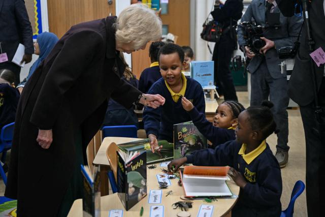 Britain's Queen Camilla (L) meets with pupils as she attends the opening of a library at Christ Church Primary School in London on February 4, 2026, to help mark the "National Year of Reading". (Photo by JUSTIN TALLIS / POOL / AFP)