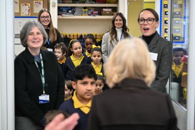 Students and staff come out to meet with Britain's Queen Camilla (foreground) as she attends the opening of a library at Christ Church Primary School in London on February 4, 2026, to help mark the "National Year of Reading". (Photo by JUSTIN TALLIS / POOL / AFP)