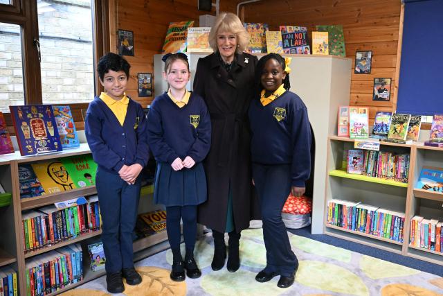 Britain's Queen Camilla (2nd R) poses with pupils as she attends the opening of a library at Christ Church Primary School in London on February 4, 2026, to help mark the "National Year of Reading". (Photo by JUSTIN TALLIS / POOL / AFP)