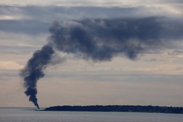 Smoke rises after a fire broke out on a 25-meter boat off Cap d'Antibes, near Nice on February 4, 2025. (Photo by Valery HACHE / AFP)
